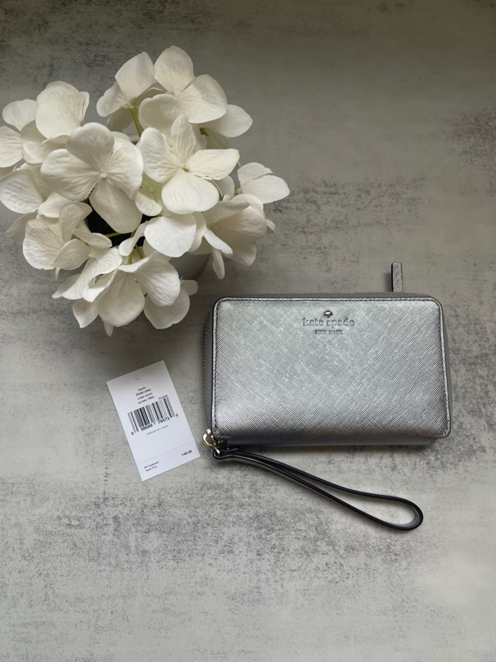 Kate Spade Laurie silver zip-around wristlet wallet